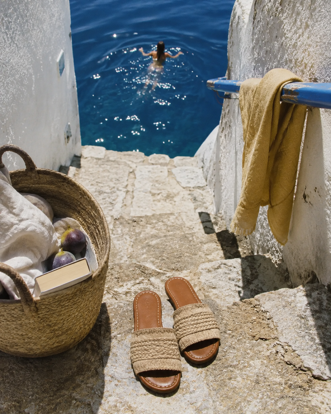 ELEMENT summer campaign — woven Namos slides on sunlit stone steps above a blue cove